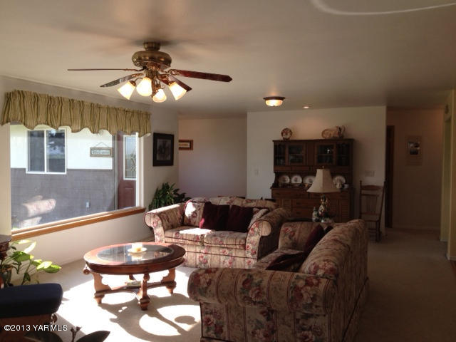 3330 Harrah Road Harrah, WA 98933 - Photo 22 of 30 a living room with furniture and a chandelier
