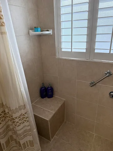 a bathroom with a sink a toilet and a window