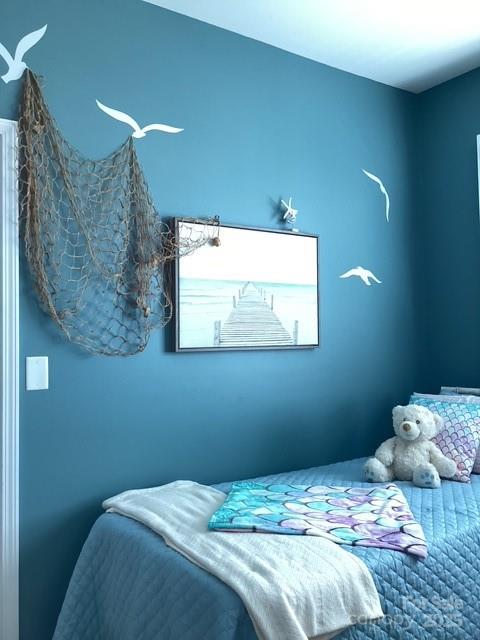 518 Pine Links Drive Tega Cay, SC 29708 - Photo 32 of 36 a bedroom with a bed and a wall painting