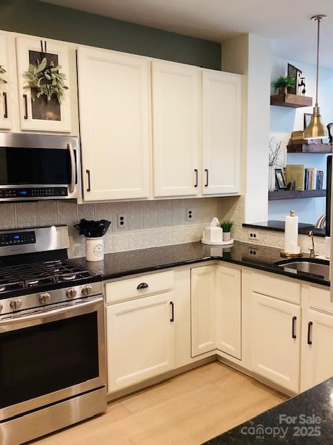 518 Pine Links Drive Tega Cay, SC 29708 - Photo 9 of 36 a kitchen with stainless steel appliances granite countertop a stove a sink and a microwave