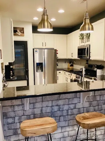 a bathroom with a sink mirror and vanity