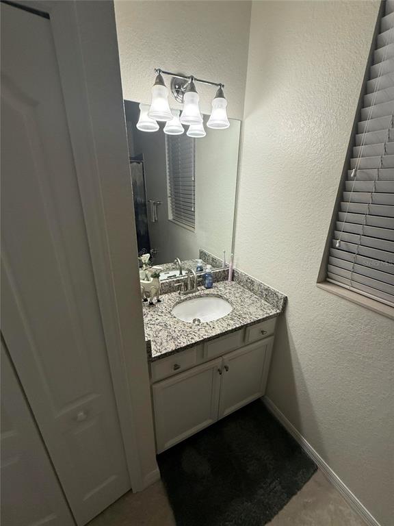 17006 Blue Ridge Place Bradenton, FL 34211 - Photo 15 of 38 a bathroom with a granite countertop sink a mirror and a shower