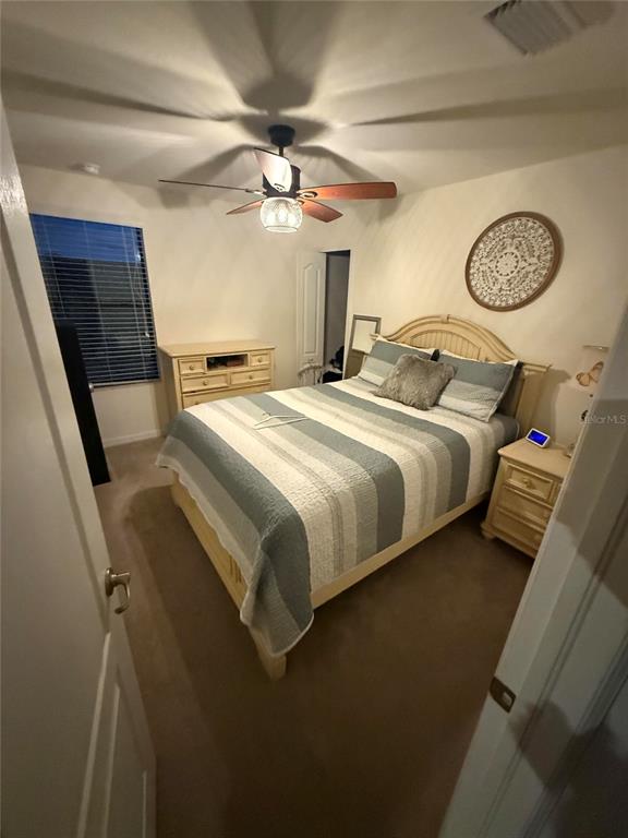 17006 Blue Ridge Place Bradenton, FL 34211 - Photo 22 of 38 a bedroom with bed and a chandelier