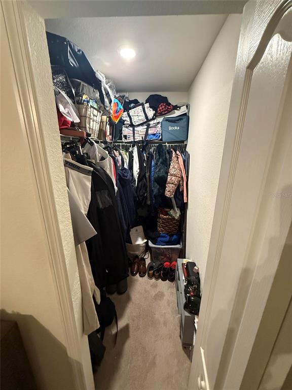 17006 Blue Ridge Place Bradenton, FL 34211 - Photo 23 of 38 a view of walk in closet with clothes and shoes