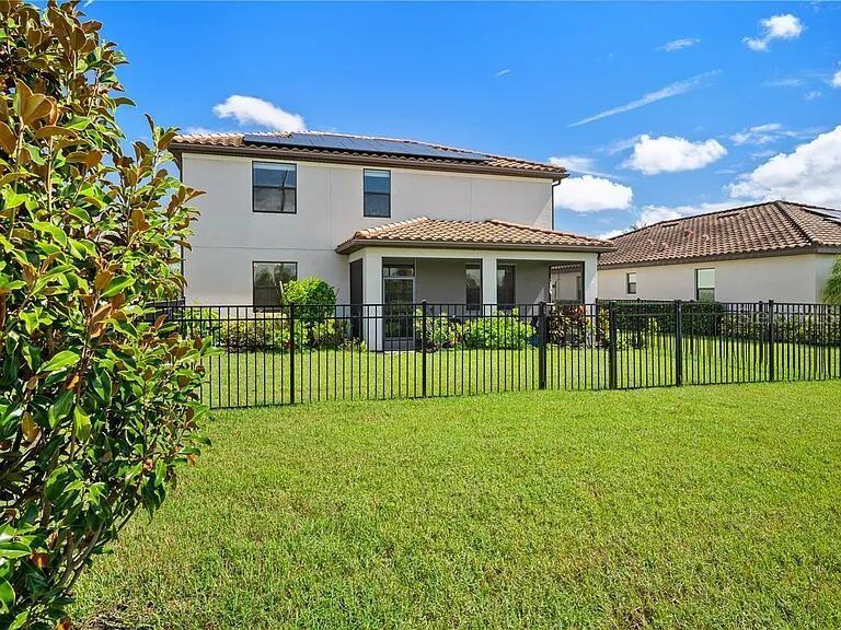 17006 Blue Ridge Place Bradenton, FL 34211 - Photo 28 of 38 a view of a house in front of a big yard with plants and wooden fence