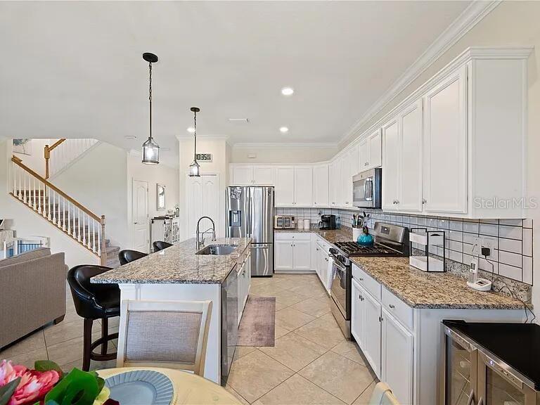 17006 Blue Ridge Place Bradenton, FL 34211 - Photo 36 of 38 a kitchen with stainless steel appliances kitchen island granite countertop a sink a stove a dining table and chairs