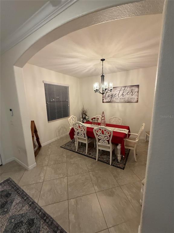 17006 Blue Ridge Place Bradenton, FL 34211 - Photo 6 of 38 a bedroom with furniture and a chandelier