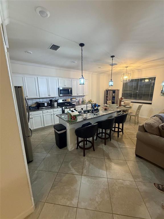 17006 Blue Ridge Place Bradenton, FL 34211 - Photo 7 of 38 a kitchen with a table chairs and a wooden floor