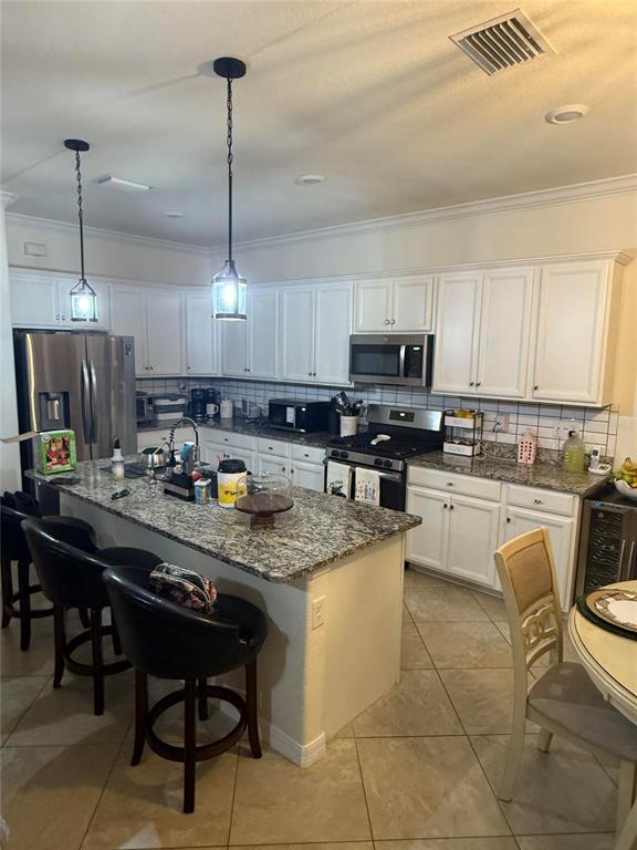 17006 Blue Ridge Place Bradenton, FL 34211 - Photo 8 of 38 a kitchen with stainless steel appliances granite countertop a stove a sink a microwave and a refrigerator