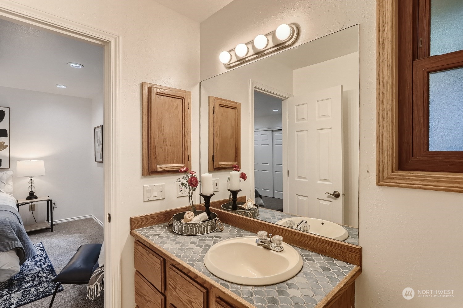 2626 242nd Place Southeast Bothell, WA 98021 - Photo 18 of 26 a bathroom with a granite countertop sink a mirror and a vanity