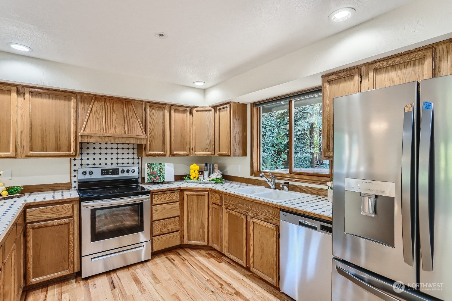 2626 242nd Place Southeast Bothell, WA 98021 - Photo 8 of 26 a kitchen with a sink stove and refrigerator
