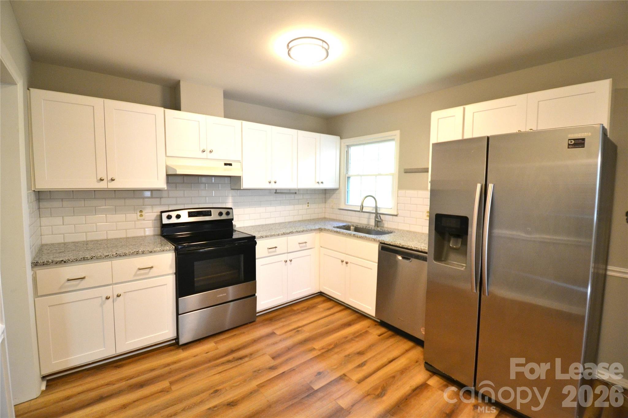1422 Thermal Road Charlotte, NC 28212 - Photo 15 of 40 a kitchen with a refrigerator stove and sink
