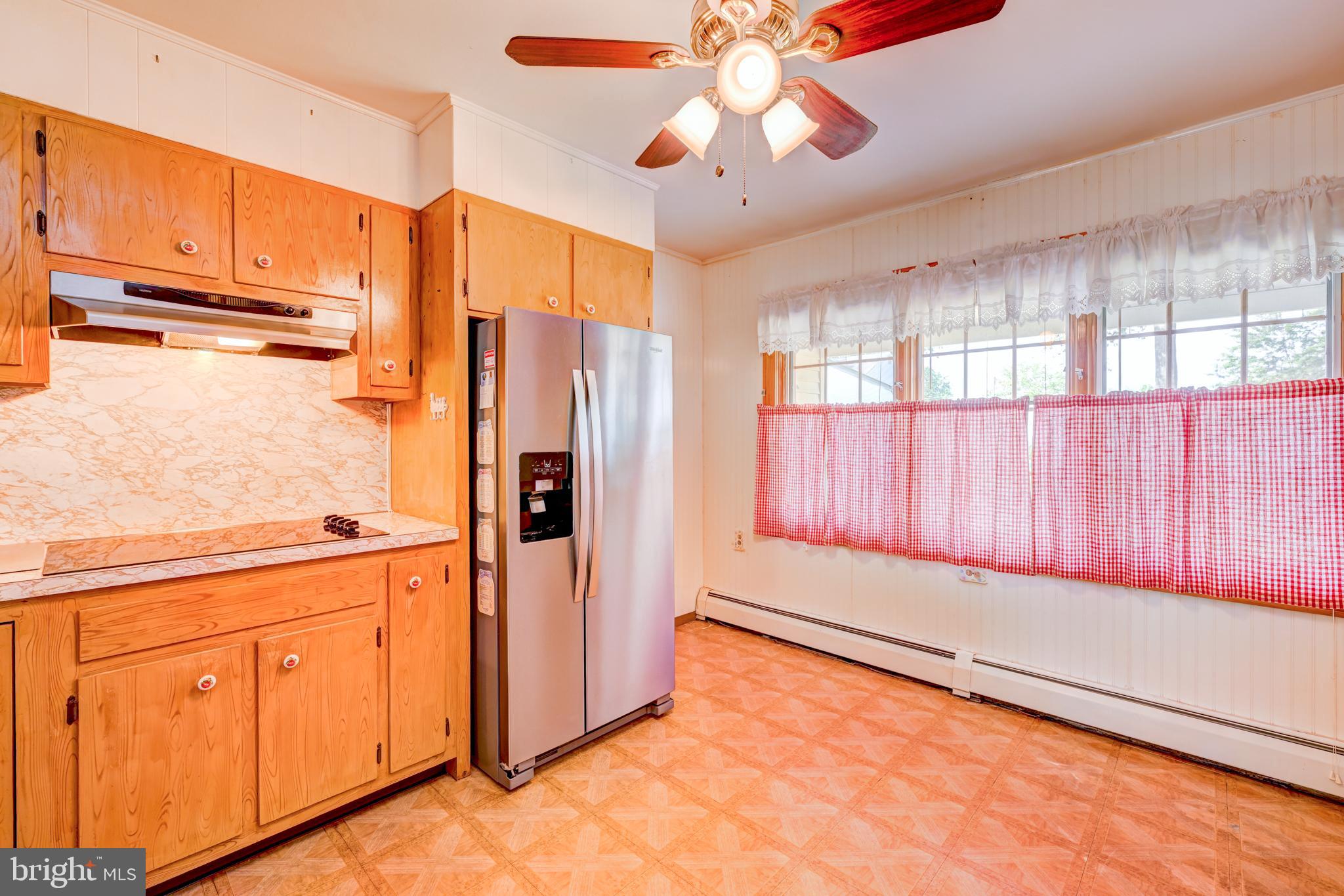 32 Gaping Rock Road Levittown, PA 19057 - Photo 8 of 28 a view of a kitchen with an empty space and wooden floor