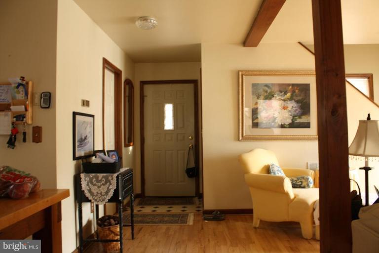 101 Carriage Court High View, WV 26808 - Photo 6 of 22 a view of a hallway with wooden floor and dining room