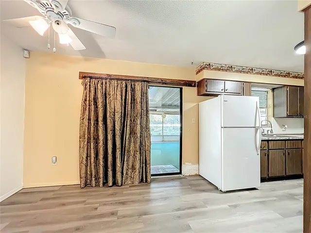 wooden floor in an empty room and a kitchen