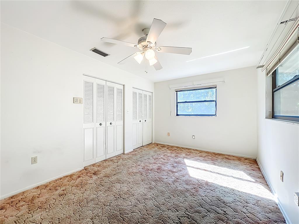 7802 Mizell Street Coleman, FL 34785 - Photo 21 of 44 a view of a big room with wooden floor and windows in a bedroom