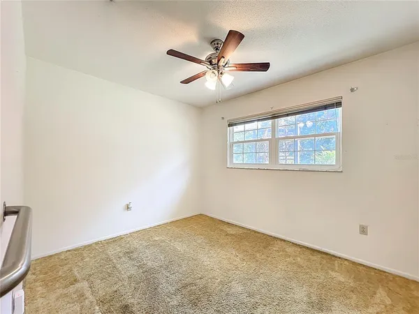 a view of a big room with wooden floor and windows