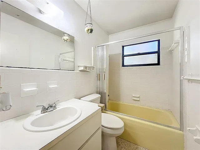a bathroom with a sink mirror toilet and bathtub