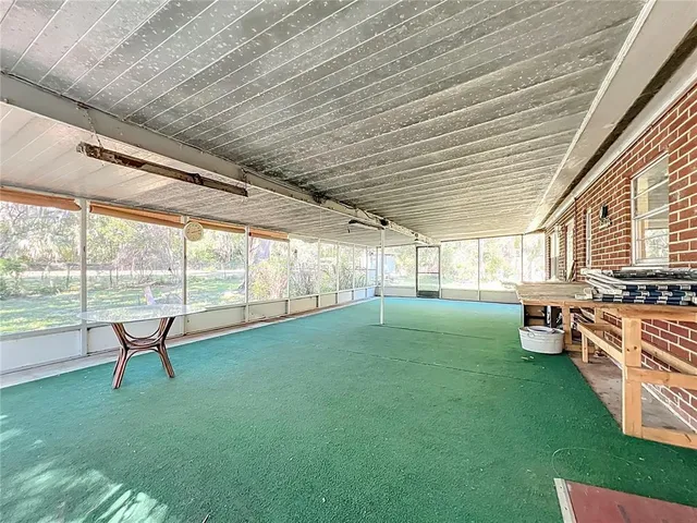 a view of a backyard with sitting area