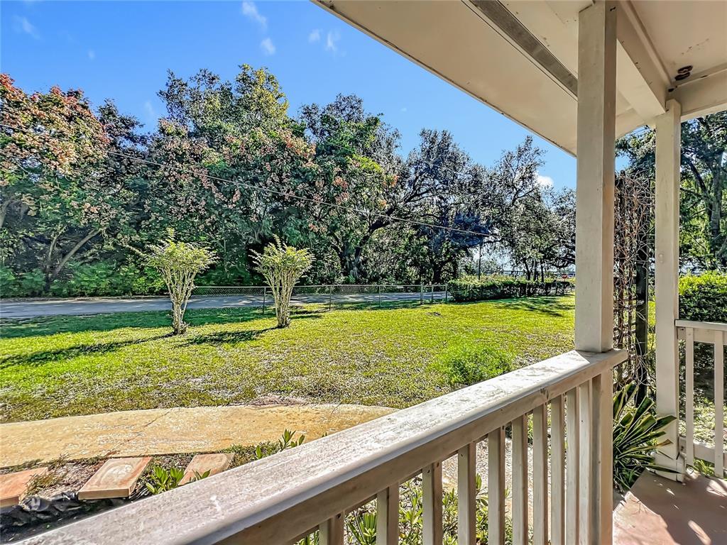 7802 Mizell Street Coleman, FL 34785 - Photo 3 of 44 a view of a yard with flower plants and wooden fence