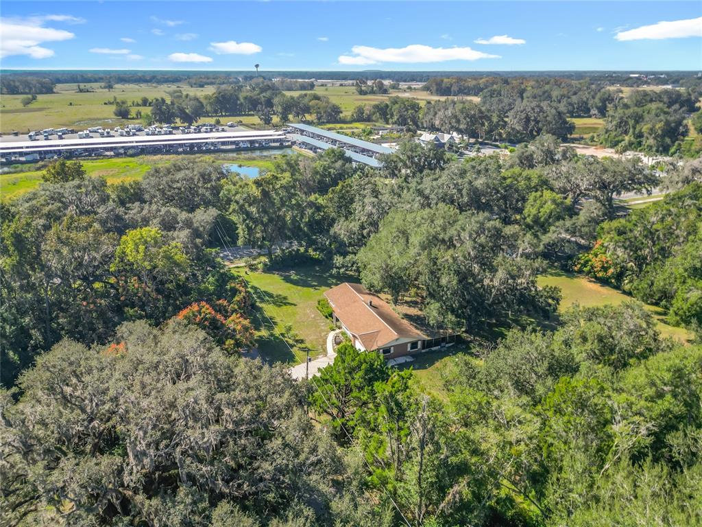 7802 Mizell Street Coleman, FL 34785 - Photo 38 of 44 an aerial view of residential houses with outdoor space and swimming pool