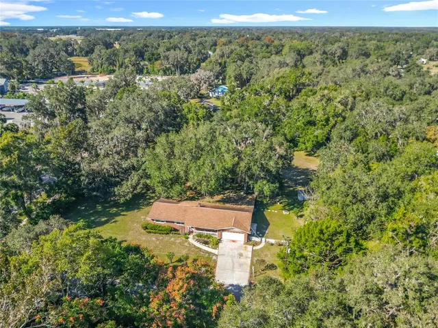 an aerial view of residential houses with outdoor space and swimming pool