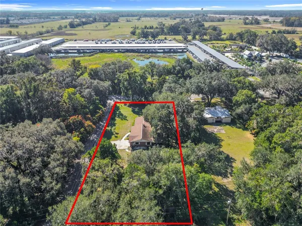 an aerial view of a residential houses with yard and swimming pool