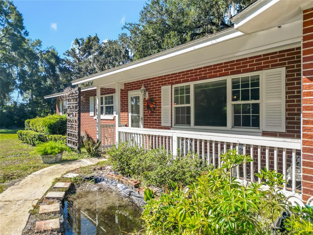 7802 Mizell Street Coleman, FL 34785 - Photo 7 of 44 a view of a house with a flower garden