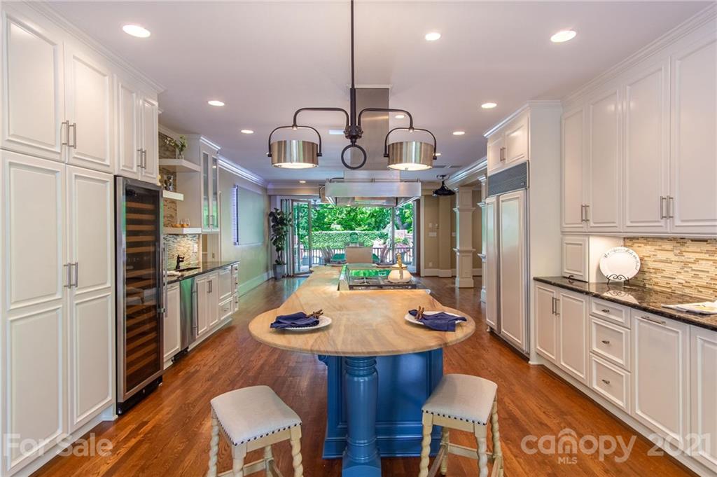 2132 Rolston Drive Charlotte, NC 28207 - Photo 13 of 48 a kitchen with stainless steel appliances a dining table chairs sink and refrigerator