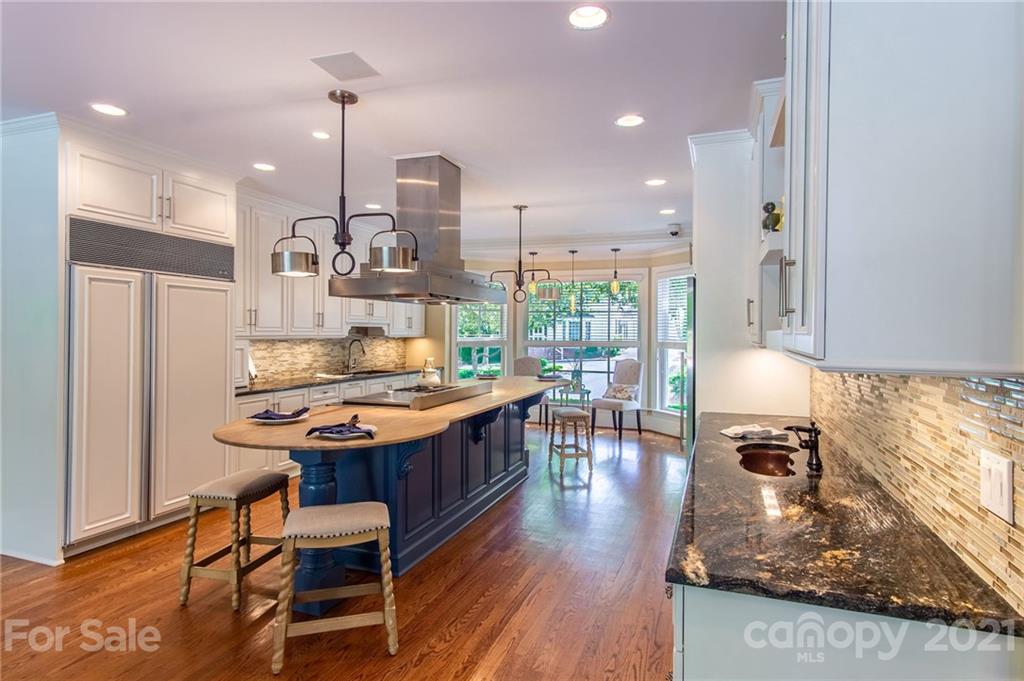 2132 Rolston Drive Charlotte, NC 28207 - Photo 14 of 48 a kitchen with stainless steel appliances granite countertop a stove and refrigerator