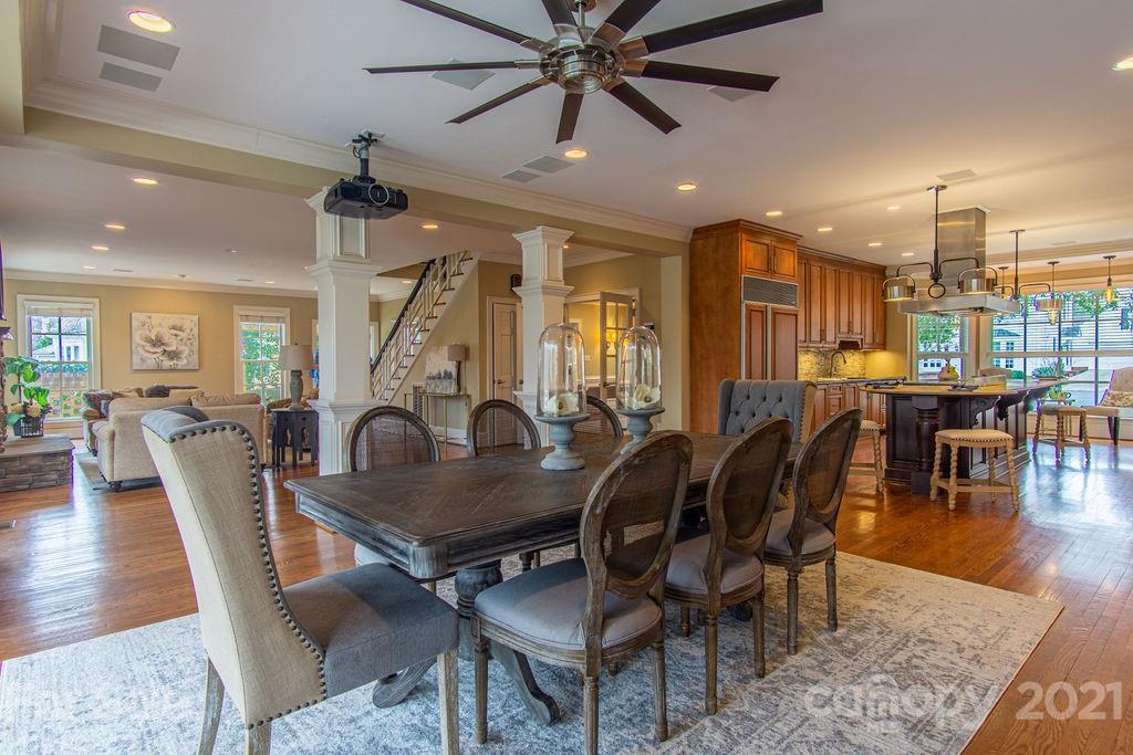 2132 Rolston Drive Charlotte, NC 28207 - Photo 17 of 48 a living room with furniture a wooden floor and chandelier