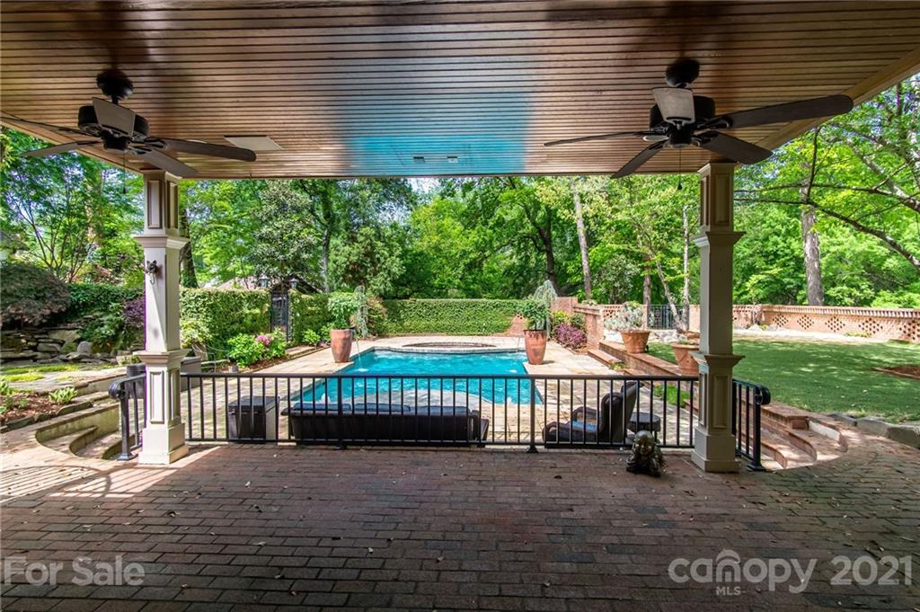 2132 Rolston Drive Charlotte, NC 28207 - Photo 25 of 48 a view of a patio with table and chairs under an umbrella with a small yard
