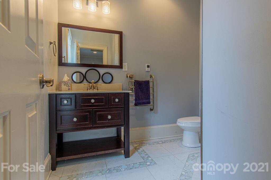 2132 Rolston Drive Charlotte, NC 28207 - Photo 32 of 48 a bathroom with a toilet a sink and a mirror