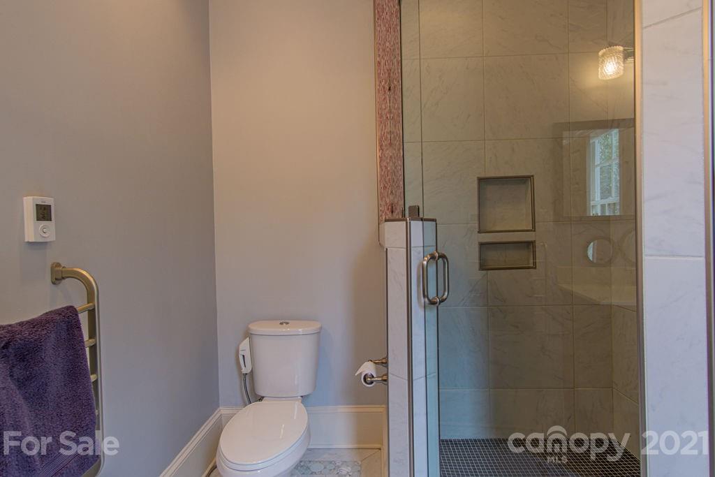 2132 Rolston Drive Charlotte, NC 28207 - Photo 33 of 48 a white toilet sitting next to a bathroom sink