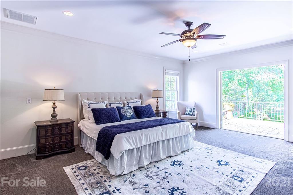 2132 Rolston Drive Charlotte, NC 28207 - Photo 37 of 48 a bedroom with a large bed and a chandelier