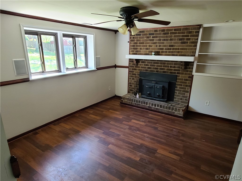 9326 Emmett Road Glen Allen, VA 23060 - Photo 20 of 29 an empty room with wooden floor a fireplace and windows