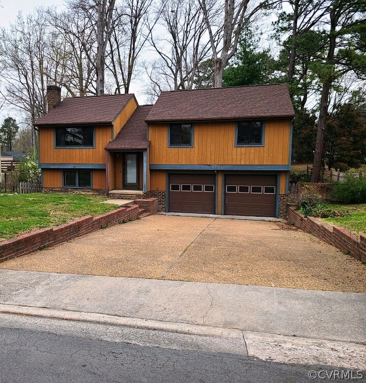 9326 Emmett Road Glen Allen, VA 23060 - Photo 2 of 29 a front view of a house with a yard and garage