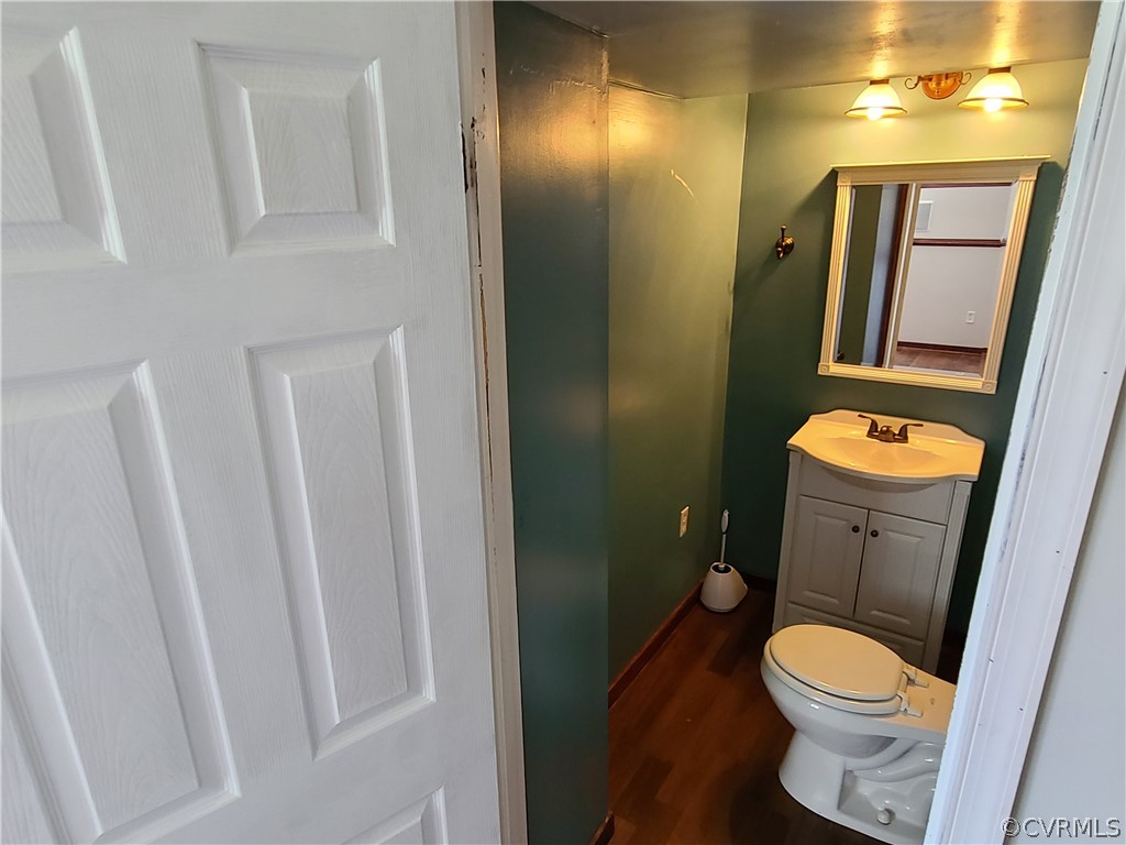 9326 Emmett Road Glen Allen, VA 23060 - Photo 23 of 29 a white toilet sitting next to a bathroom sink and a mirror