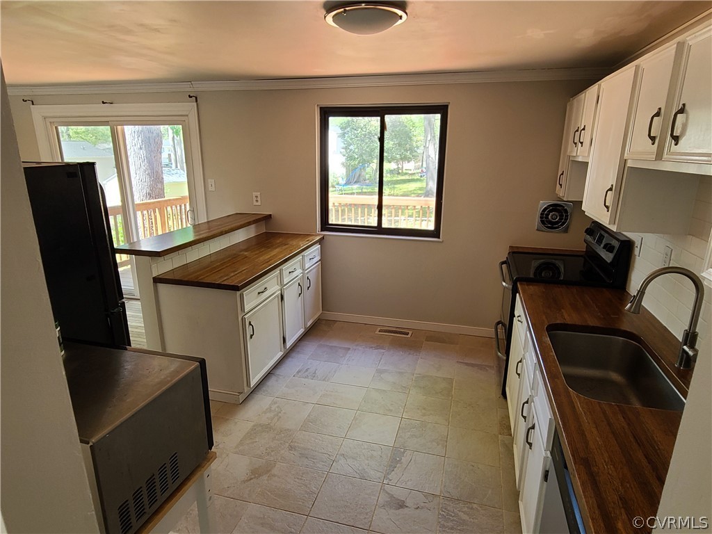 9326 Emmett Road Glen Allen, VA 23060 - Photo 5 of 29 a kitchen with a sink a refrigerator and window