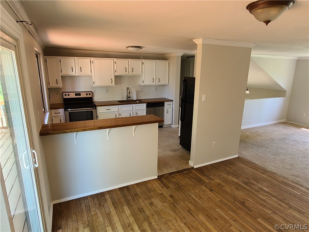9326 Emmett Road Glen Allen, VA 23060 - Photo 6 of 29 a kitchen with stainless steel appliances granite countertop a refrigerator a sink and a stove