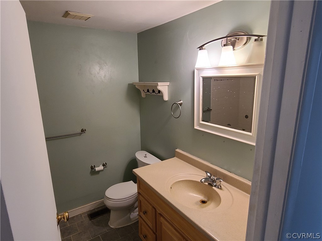 9326 Emmett Road Glen Allen, VA 23060 - Photo 9 of 29 a bathroom with a sink a toilet and mirror