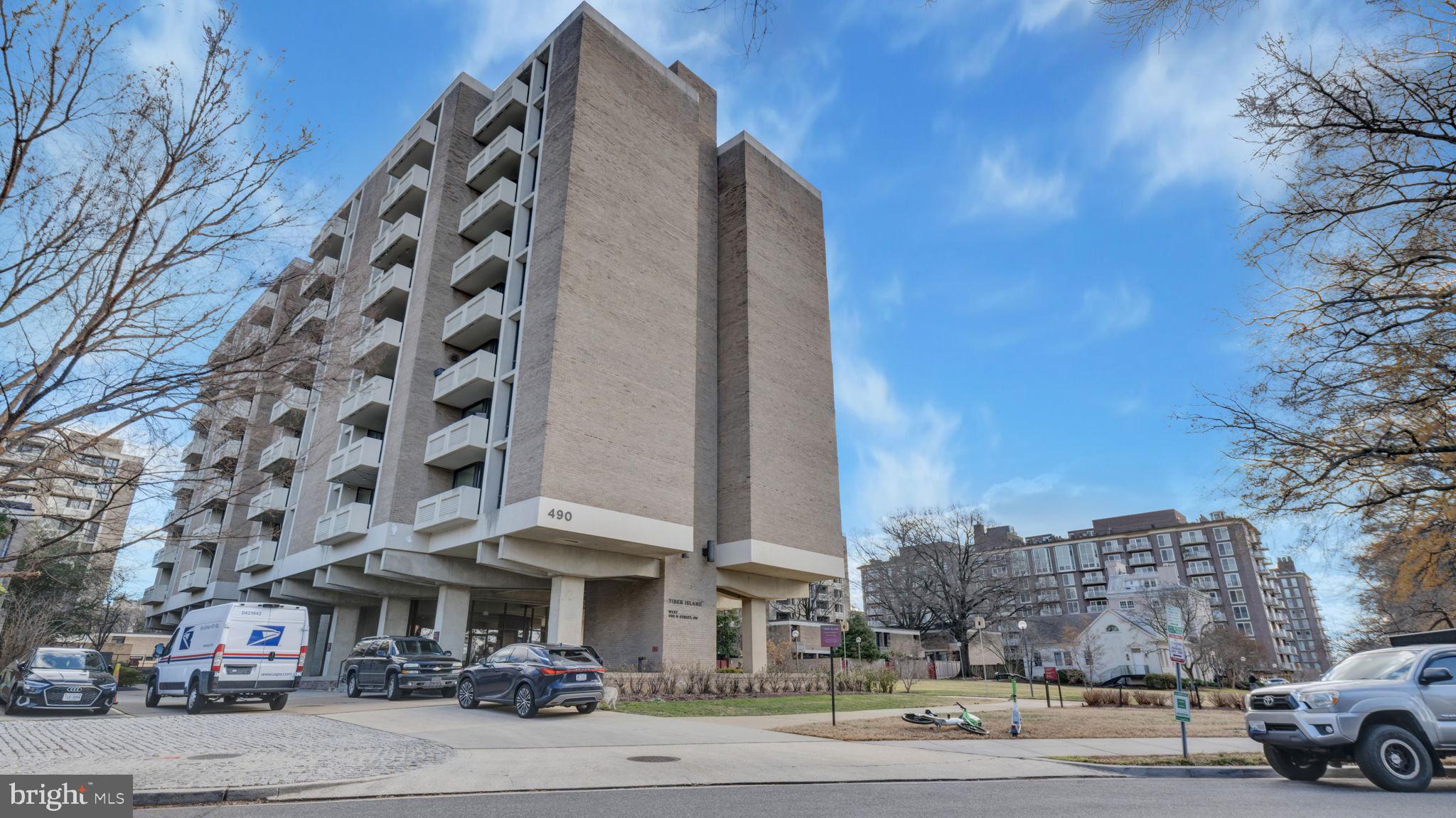 490 M Street Southwest, Unit W110 Washington, DC 20024 - Photo 1 of 11 a city street lined with buildings and cars
