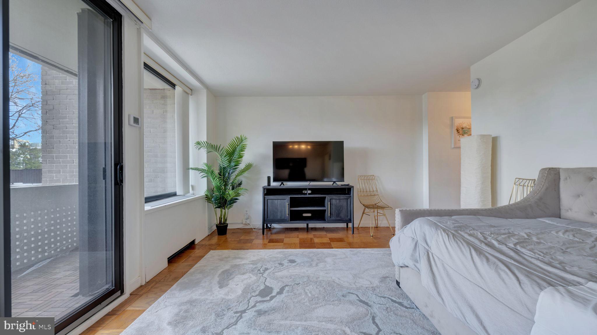 490 M Street Southwest, Unit W110 Washington, DC 20024 - Photo 4 of 11 a bedroom with a bed and a flat screen tv