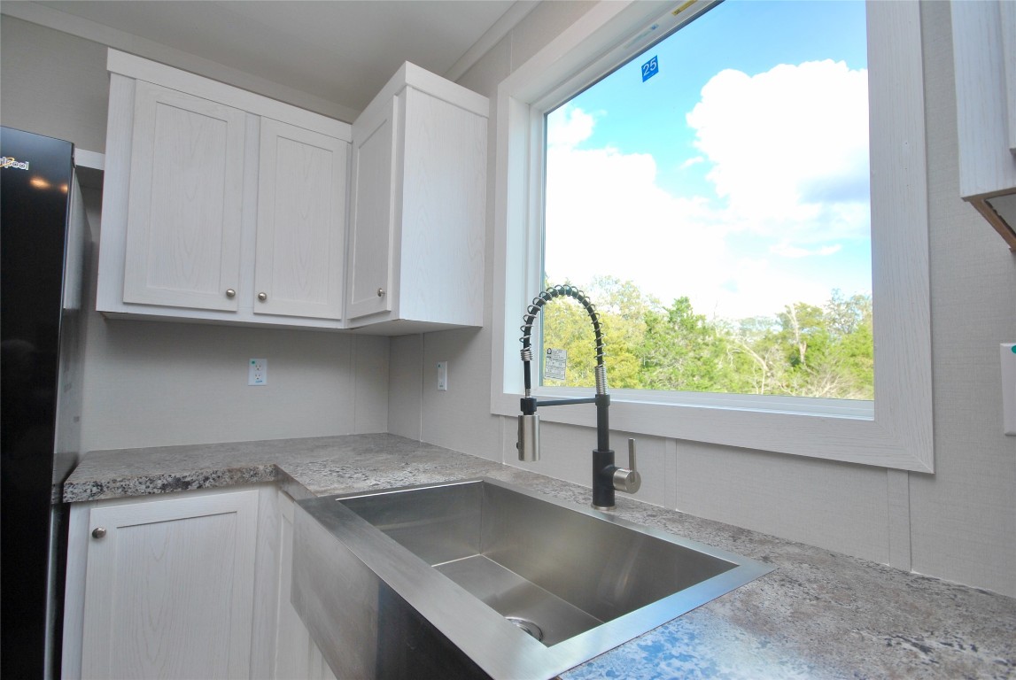 1727 Davis Road West Point, TX 78963 - Photo 8 of 40 a kitchen with stainless steel appliances granite countertop a sink and a white cabinets
