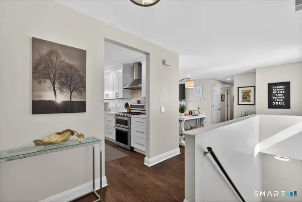 a living room with stainless steel appliances kitchen island wooden floor and view living room