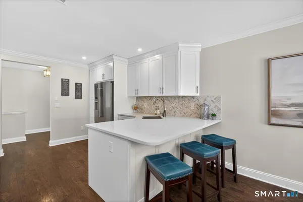 a view of kitchen with cabinets table and chairs