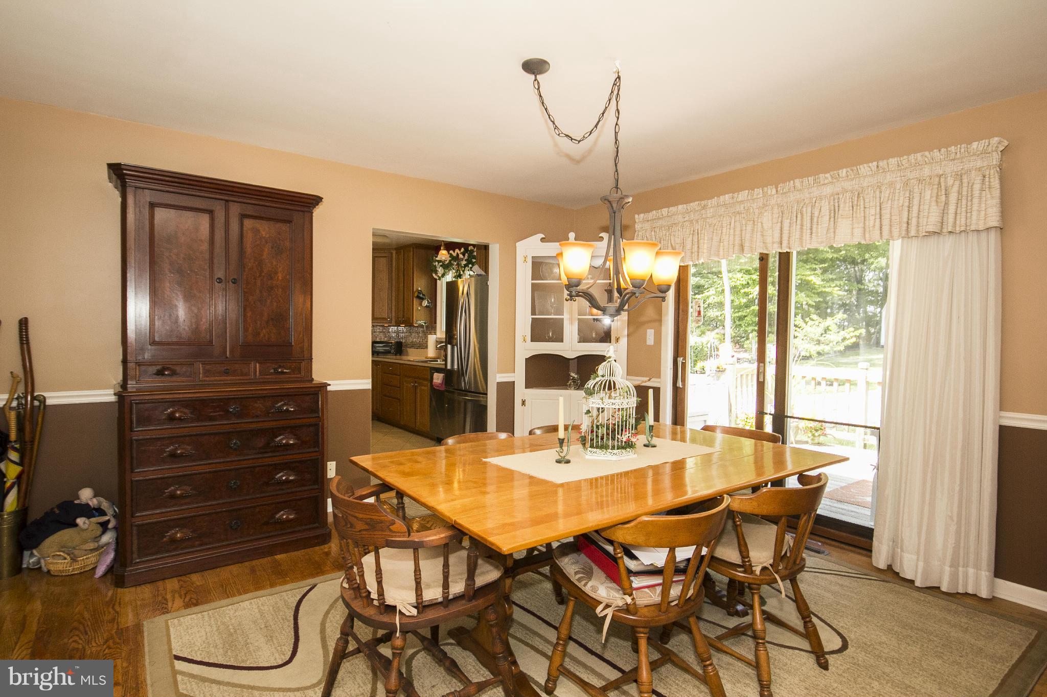 9810 Gunforge Road Perry Hall, MD 21128 - Photo 4 of 30 a dining room with furniture a chandelier and wooden floor