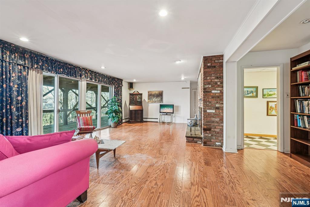 873 Olentangy Road Franklin Lakes, NJ 07417 - Photo 32 of 41 a living room with furniture floor to ceiling window and wooden floor