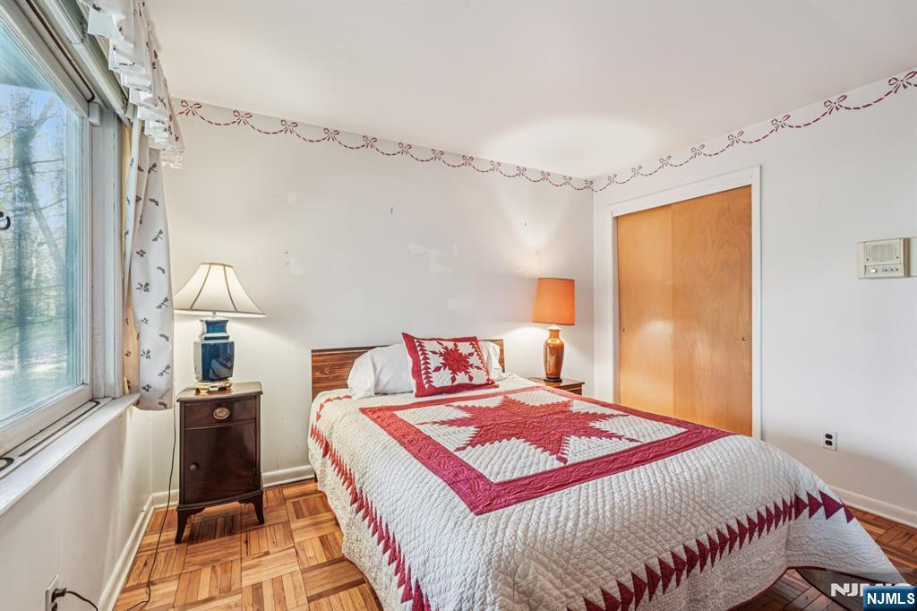 873 Olentangy Road Franklin Lakes, NJ 07417 - Photo 36 of 41 a bedroom with a bed and a chandelier