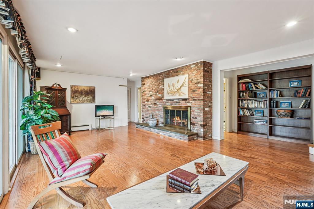 873 Olentangy Road Franklin Lakes, NJ 07417 - Photo 39 of 41 a living room with furniture a fireplace and a flat screen tv